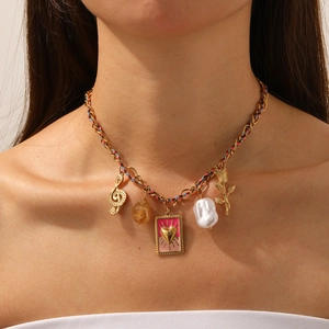 Pink heart and rose gold charm necklace with pearls and notes on a woven chain