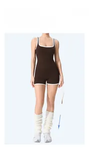 Detail of coffee brown yoga jumpsuit with white contrast piping and elastic knit fabric
