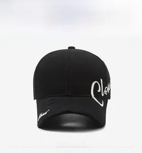 Close-up of black baseball cap with distressed brim and white Cloud embroidery