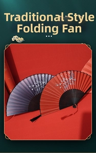 Detail of red and purple Chinese folding fans with plum blossoms and silk tassels