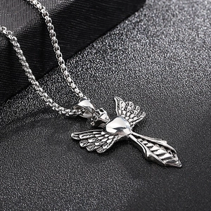 Detailed close-up of a silver angel wing cross pendant on a classic box chain