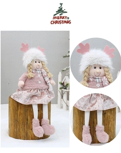 Detailed view of pink plush Christmas girl doll with reindeer antlers and knit scarf