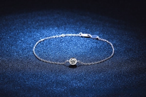 Detail of s925 silver moissanite bracelet with bezel-set center stone and adjustable chain