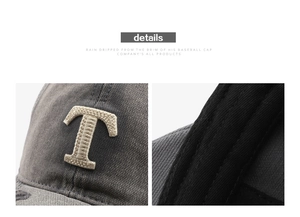 Close-up of vintage charcoal baseball cap showing detailed letter T embroidery and stitching