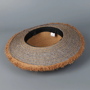 Detail of denim and raffia straw sun hat showing inner sweatband and frayed edges