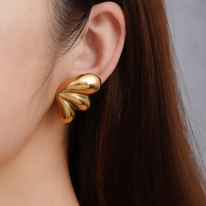 Gold minimalist 18k plated stainless steel triple drop earrings worn by model