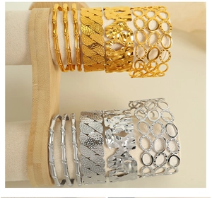 Detail of elegant bamboo-style and hammered gold and silver bracelets on jewelry display