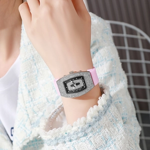 Detailed view of women's tonneau-shaped diamond watch with pink silicone strap