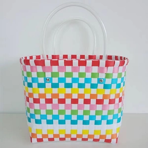Colorful woven rainbow tote bag with transparent handles and sturdy metal rivets
