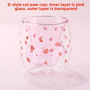 Detail of double-walled cat paw glass cup with cherry blossom petals and pink inner layer