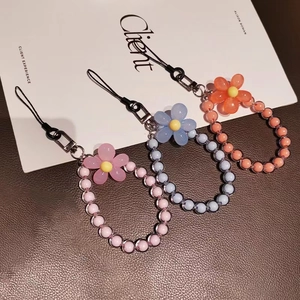 Colorful macaron beaded phone wrist strap set with floral charms in pink, blue, and orange