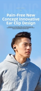 Outdoor close-up of a man wearing a black clip-on wireless earphone against a blue sky