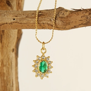Detailed close-up of 18K gold stainless steel sunflower necklace with green gemstone