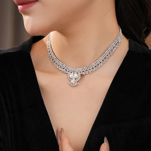 Close-up of layered water-drop pendant necklace with sparkling rhinestones on model