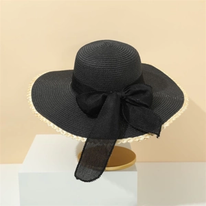 Elegant black wide-brim straw sun hat with large bow and contrasting beige trim