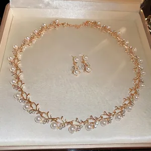 Luxury gold vine necklace and earrings set with white pearls and sparkling diamonds