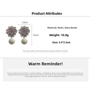Detailed macro view of blue resin rose earrings with green marbled glass beads
