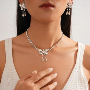 Elegant silver bowknot rhinestone pendant necklace and earrings jewelry set on model