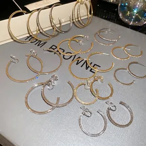 Sparkling crystal hoop earrings in gold and silver finish with ear studs and clip options