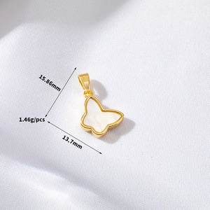 Detail of golden butterfly pendant with white shell inlay, size 15.86x13.7mm
