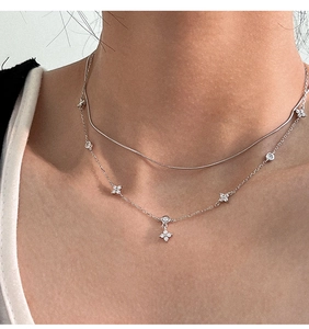 Close-up of a double-layer S925 silver snake chain necklace with floral zircon pendant
