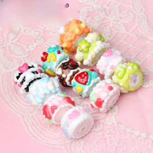 Macro shot of colorful hand-painted resin beads with 3D floral and fruit patterns for DIY