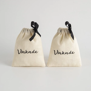 Bamboo cotton drawstring pouch with black bow tie and printed logo on white background