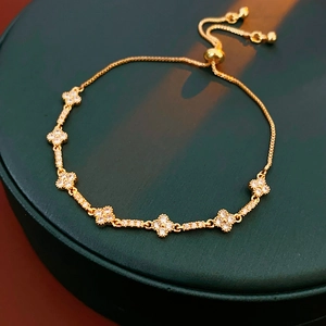 Close-up of gold flower bracelet with cubic zirconia and adjustable slider clasp