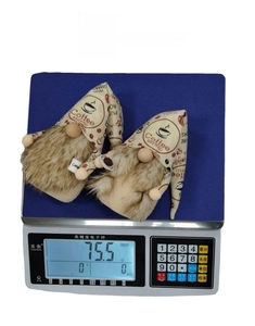 Detailed view of coffee gnome set weighing 75.5g on a digital scale for Christmas decor