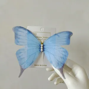 Detail of 15cm fairy blue gradient tulle butterfly hair clip with pearl accents