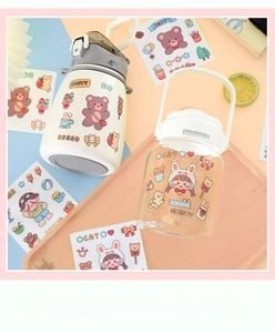 Detail of waterproof PVC cartoon stickers featuring cute bears and cats on water bottles