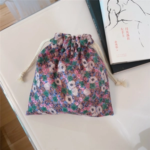 Detailed view of floral cotton drawstring pouch with artistic oil painting pattern