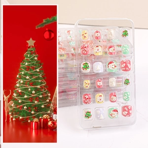 Kids Christmas press-on nails set featuring Santa Claus and reindeer holiday patterns