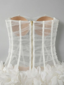 Macro shot of corset back with mesh boning, gold zipper and 3D fabric flower petals