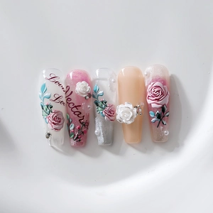 3D floral press-on nails with embossed roses, pearls, and pink glitter in coffin shape