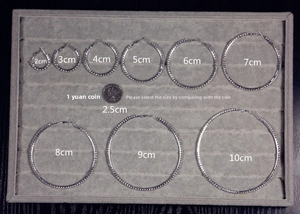 Size chart for oversized crystal hoop earrings with rhinestone comparison to a coin