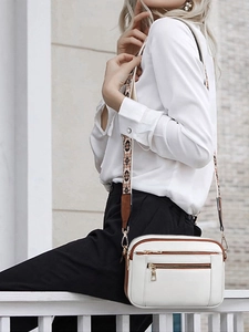 Detail of white PU crossbody bag with adjustable ethnic pattern shoulder strap