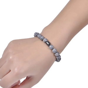 8mm grey marble bead bracelet with black magnetic stone cylinder worn on wrist