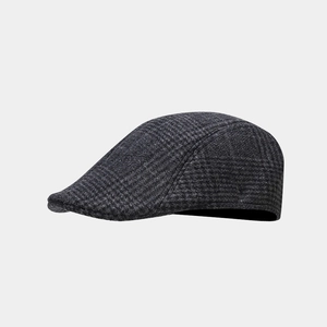 Detail of grey plaid newsboy cap showing fine wool texture and classic vintage stitchwork
