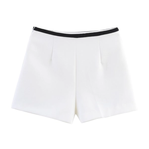 Detail of high-waisted white dress shorts with contrasting black waistband trim for women