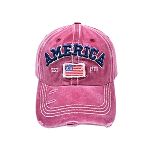 Detail of vintage distressed baseball cap with blue America embroidery and USA flag patch