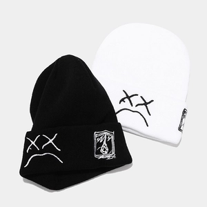 Unisex knitted beanies with embroidered face and folded cuff in black and white