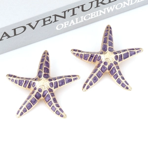 Elegant gold starfish earrings with purple enamel inlay and bead details on white background