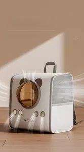 Detail of white pet carrier with clear bubble window and four metal ventilation ports