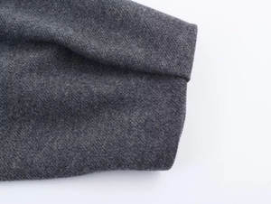 Close-up of high-quality dark grey twill knit fabric texture and professional stitching