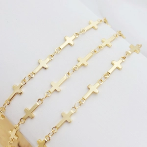 Close-up of golden metal cross chain links for DIY necklaces and jewelry making