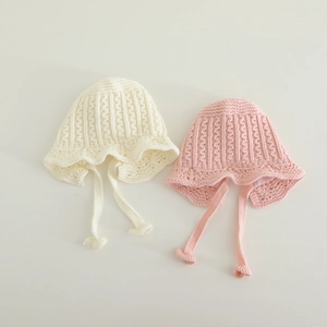 Winter knitted baby hats with lace trim and chin straps in cream white and soft pink colors