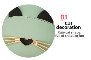 Detailed close-up of mint green cat-shaped bag featuring heart nose and golden whiskers