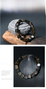 Detailed view of square dark agarwood beads with golden spacers in a Zen style
