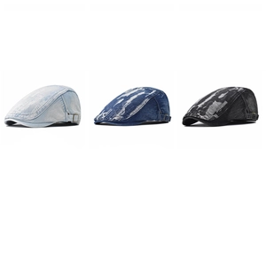 Three distressed denim newsboy caps in light blue, dark blue, and charcoal grey wash colors